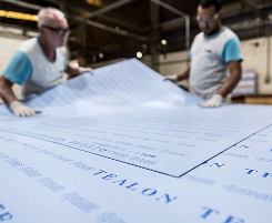 Teadit employees handling Tealon gasket sheets